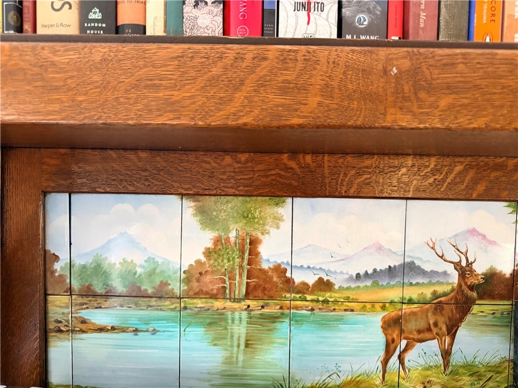 Detail of hand painted tiles on bedroom mantle