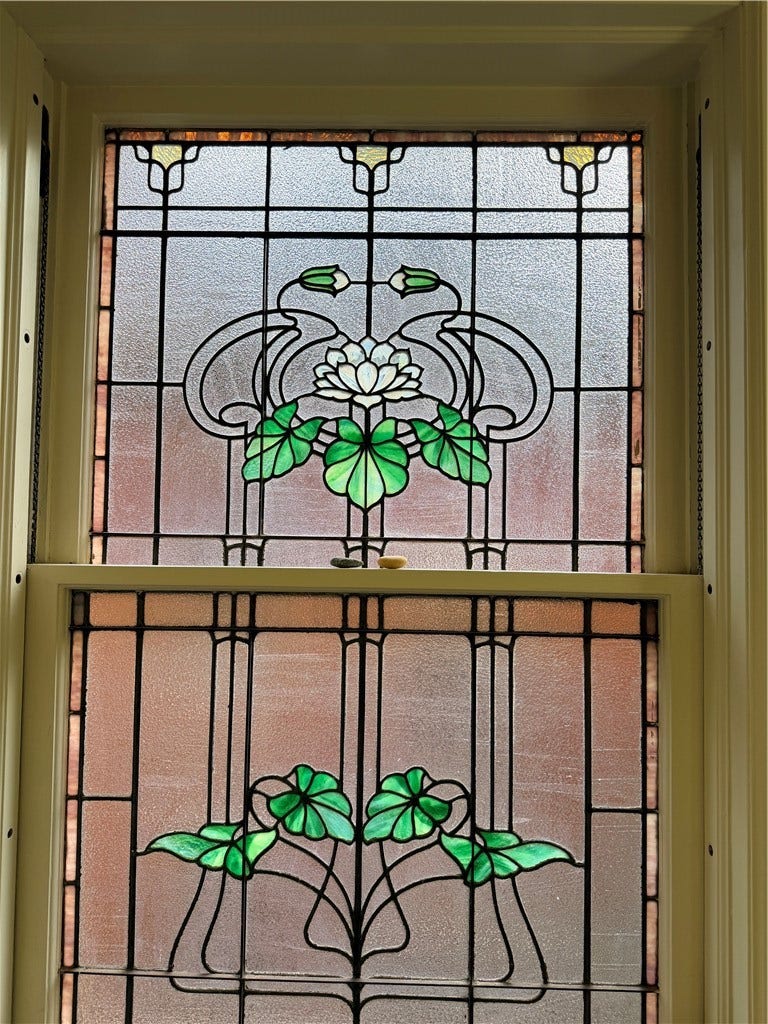 Detail of bathroom window with original stained glass.
