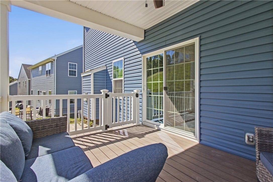 Glass slider leads the way to this awesome covered deck.
