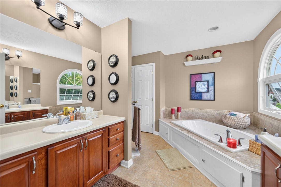 306 Crimson Drive, Pittsburgh, PA 15237 Spa like primary bathroom with wooded views in the distance.