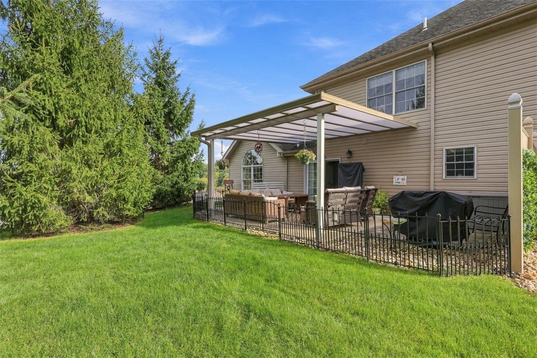 Beautiful grassy area offers additional outdoor space, perfect for pets to enjoy.