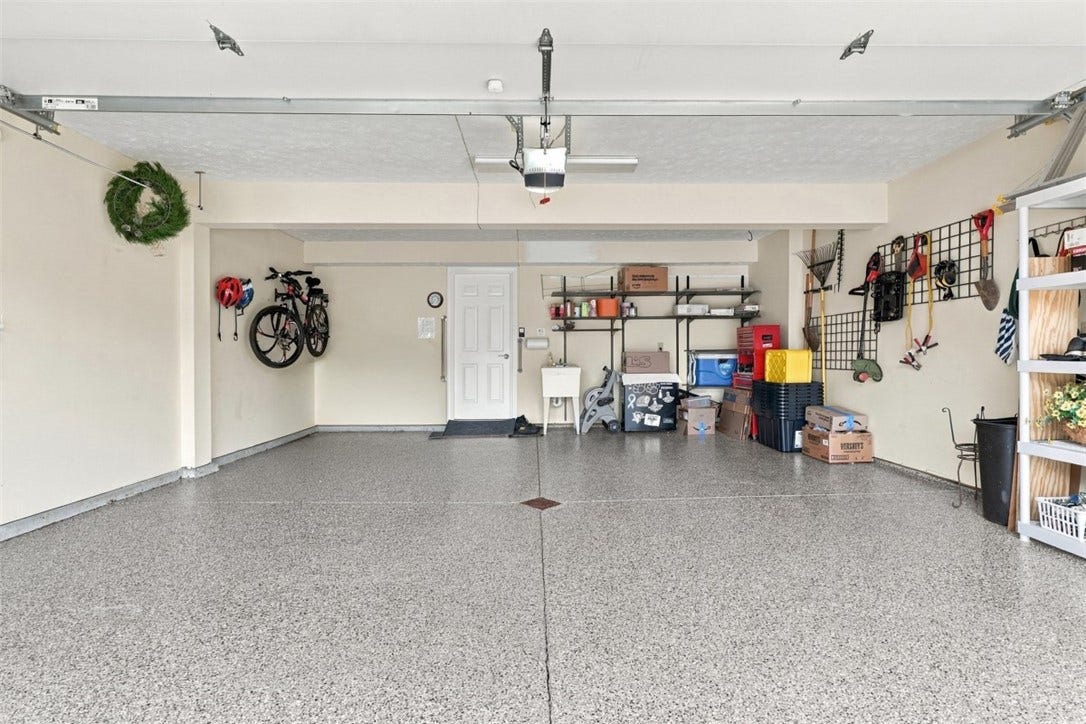 Extra large, 2 car garage with newly epoxied floors.