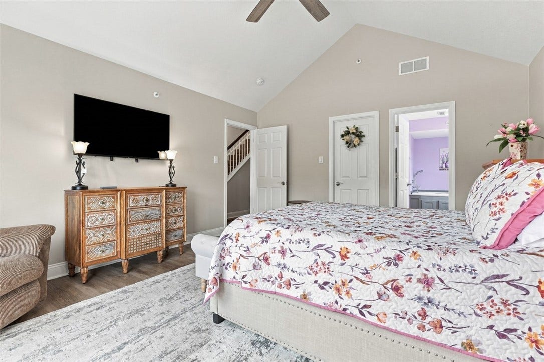 Main-level primary suite with private en suite bath and walk-in closet.
