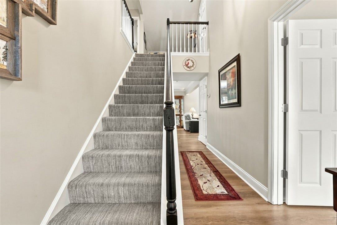 Spacious entrance foyer with stairs leading to bedrooms #2 and #3, a full bath and an abundance of additional storage.