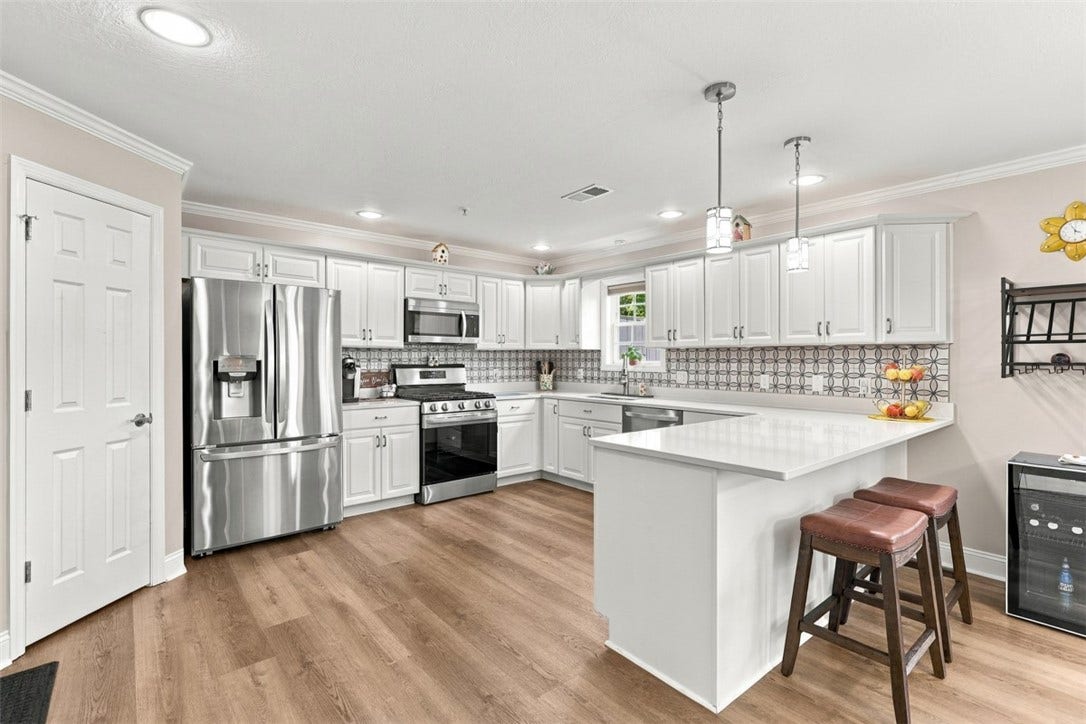 Stunning, updated eat-in kitchen with an abundance of cabinet and counter space, plus a designated pantry area for additional storage.