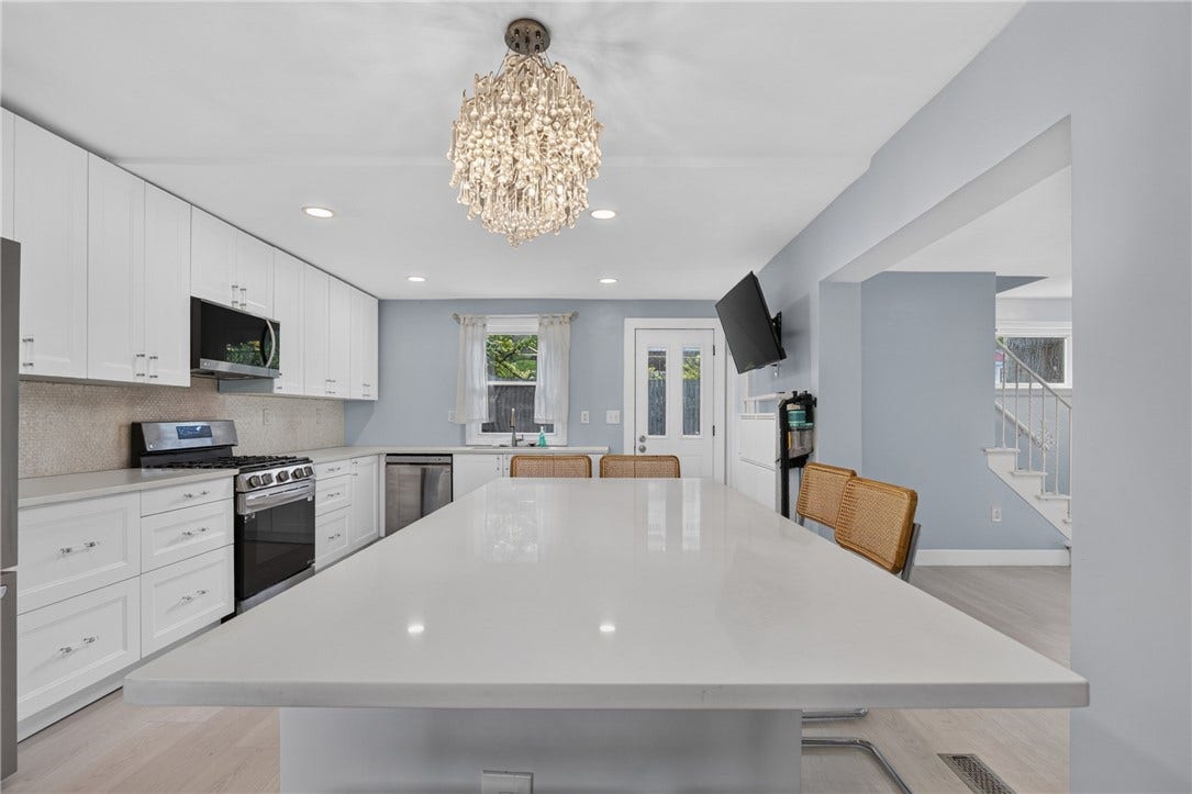 Kitchen (25x13), featuring a very large island & seating