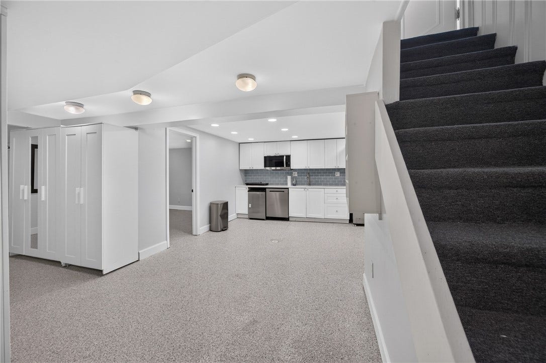 Lower Level (22x10), leading to Full Bathroom, Kitchenette, cabinet storage off of garage, large Den or Office