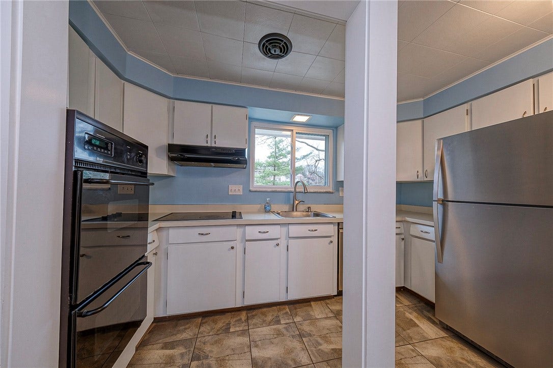 The kitchen has a new fridge and dishwasher.