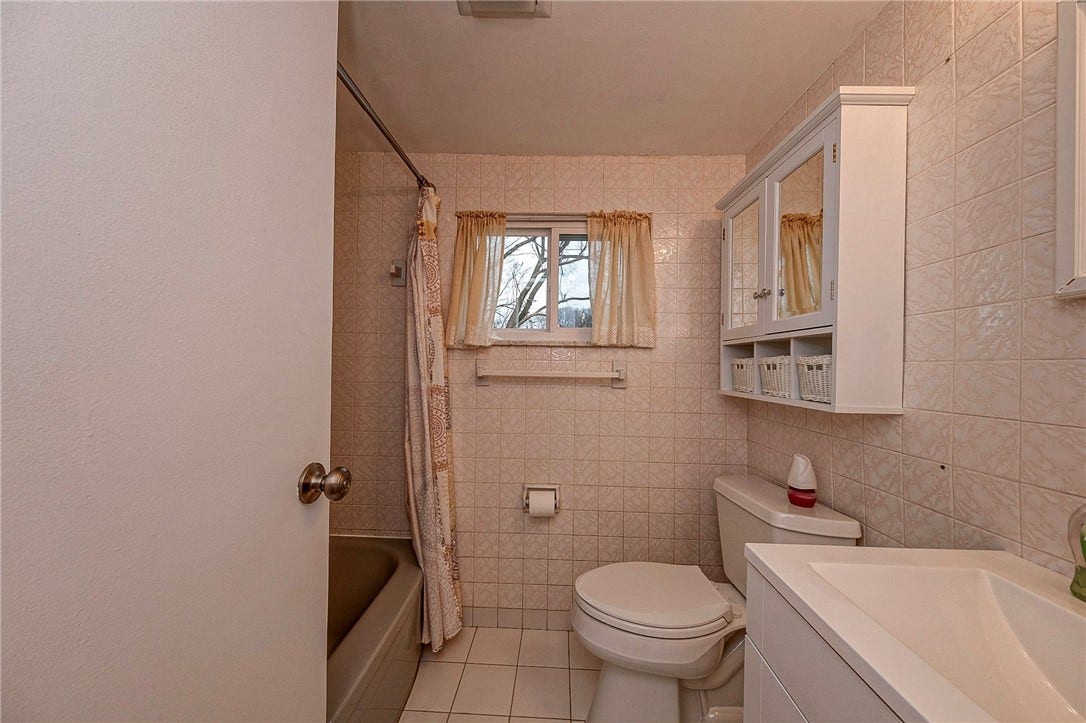 A full bathroom is conveniently located on the middle level adjacent to 2 of the bedrooms.