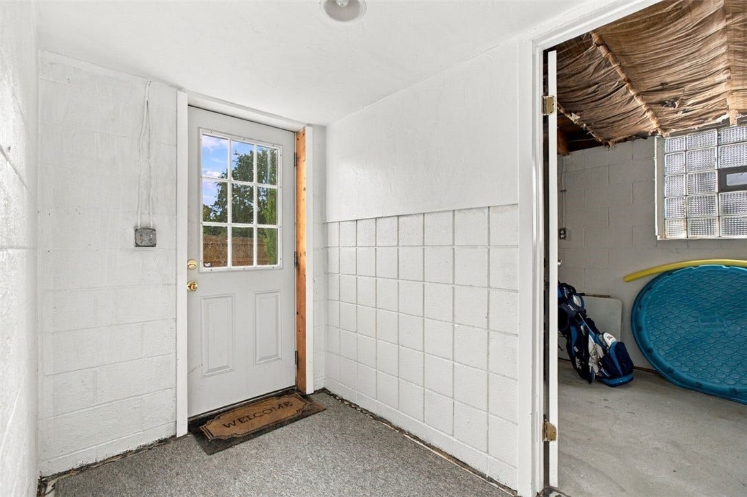 Convenient mud room area leads directly to the backyard