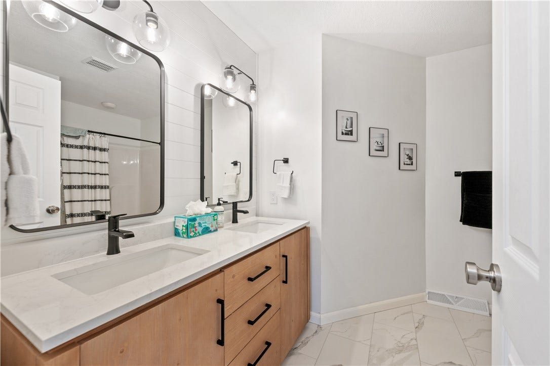 This beautifully updated hall bath is straight out of a magazine...