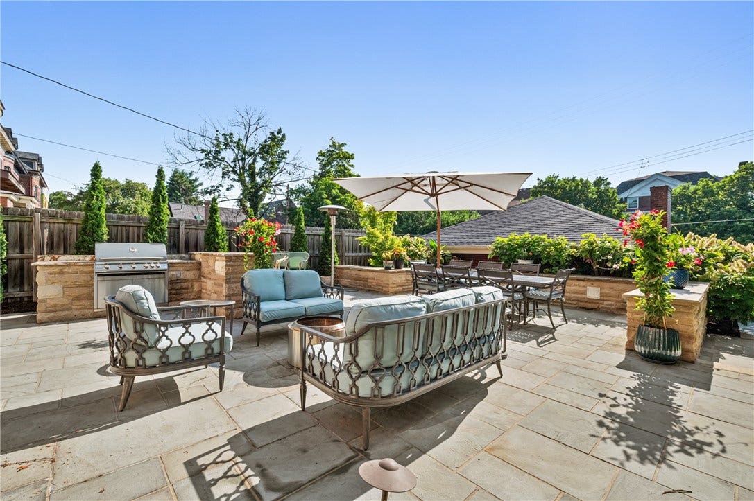 Outdoor living space, yes please!  Expansive patio, built-in gas grill with granite counters and green space-not one detail has been overlooked
