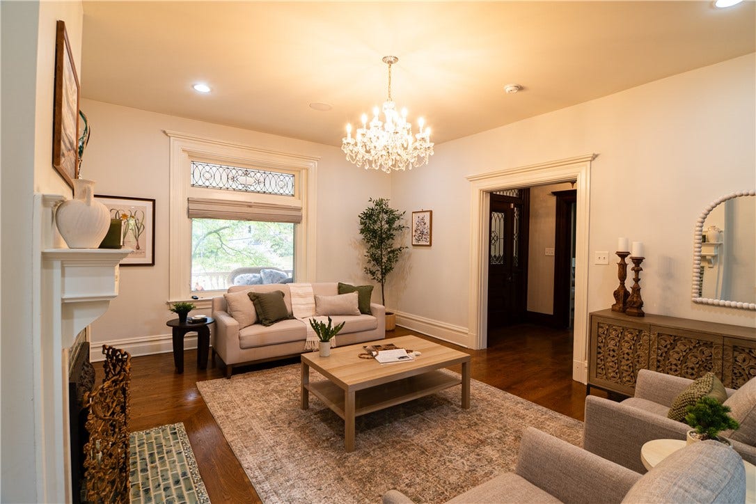 Illuminated by a vintage chandelier, the living room is perfect for entertaining or curling up to watch TV