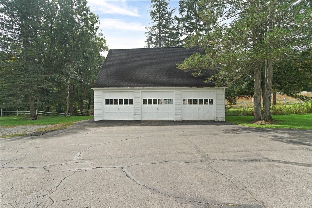 Detached three car garage (will convey as-is)