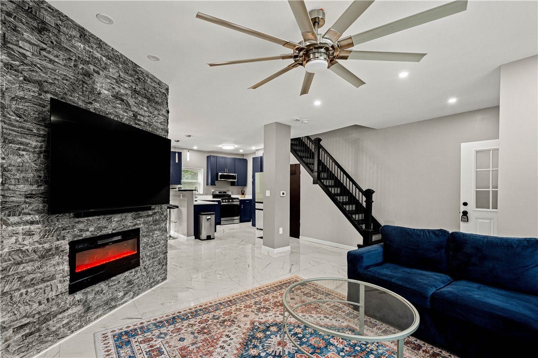 214 N Aiken Ave, Pittsburgh, PA 15206 Floor-to-ceiling stone wall, recessed lighting and modern ceiling fan