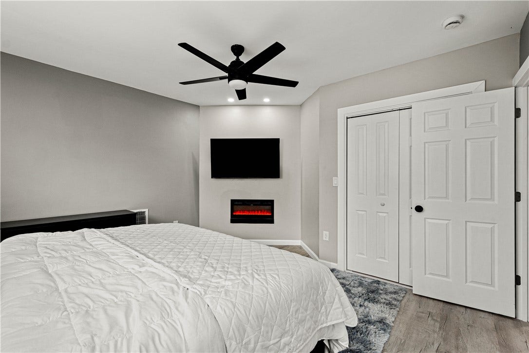214 N Aiken Ave, Pittsburgh, PA 15206 Second-floor bedroom with electric fireplace and closet