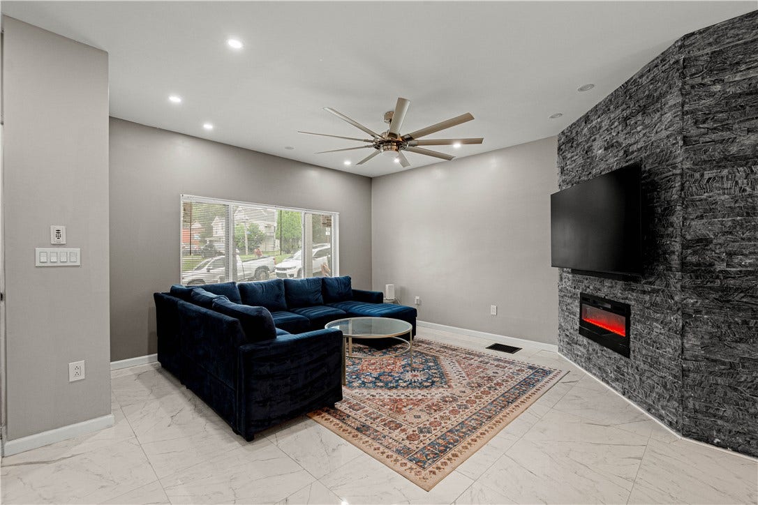 214 N Aiken Ave, Pittsburgh, PA 15206 Living room with electric fireplace and wall-mounted TV