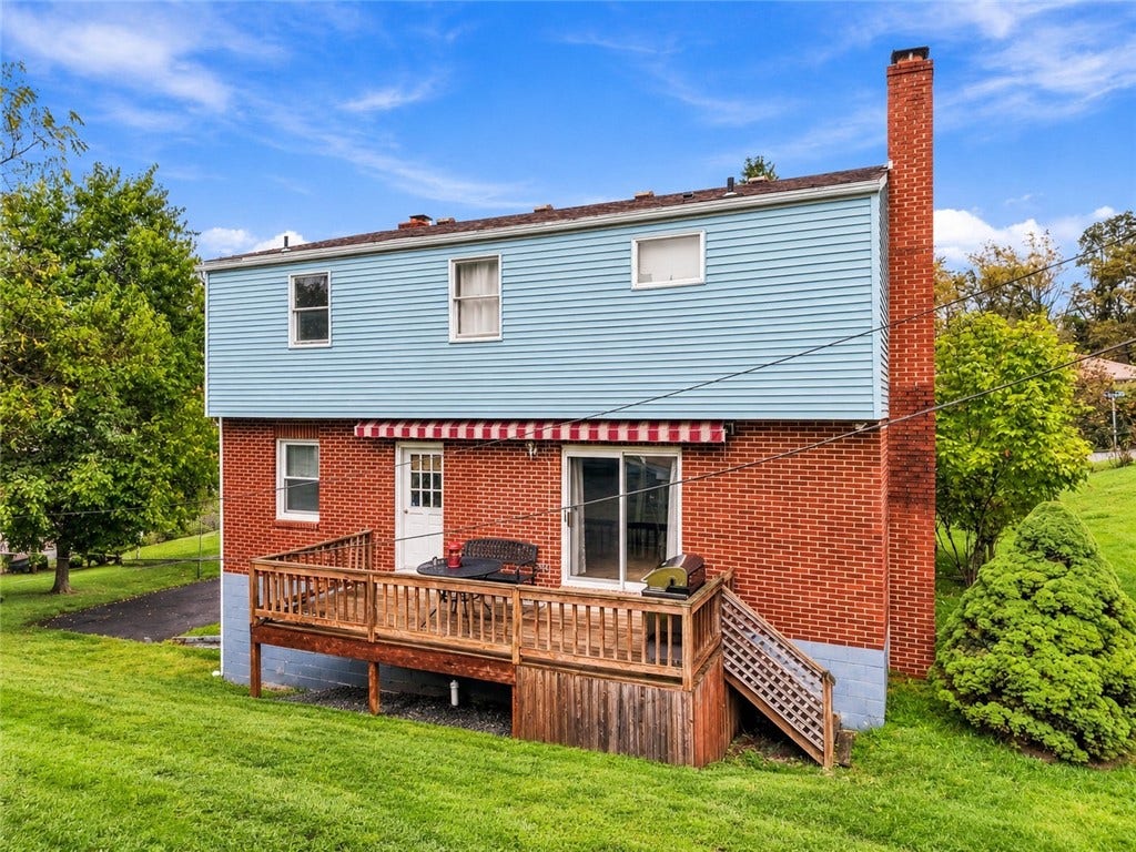 Spacious back deck is the perfect spot for grilling and entertaining! Virtual photo since the back fence is being removed.