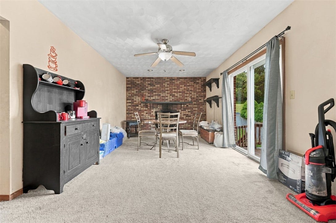 This dining room brings the charm with a cozy brick fireplace and easy access to the deck- perfect for dinners, gatherings, and everything in between!