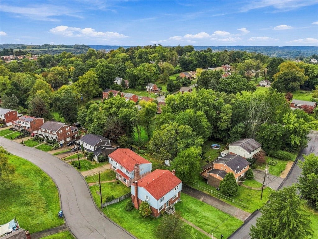 Aerial view of the neighborhood and the wonderful corner lot.