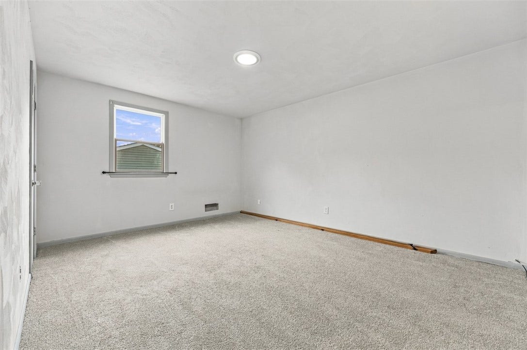 Another spacious upstairs 3rd bedroom with a neutral palette.