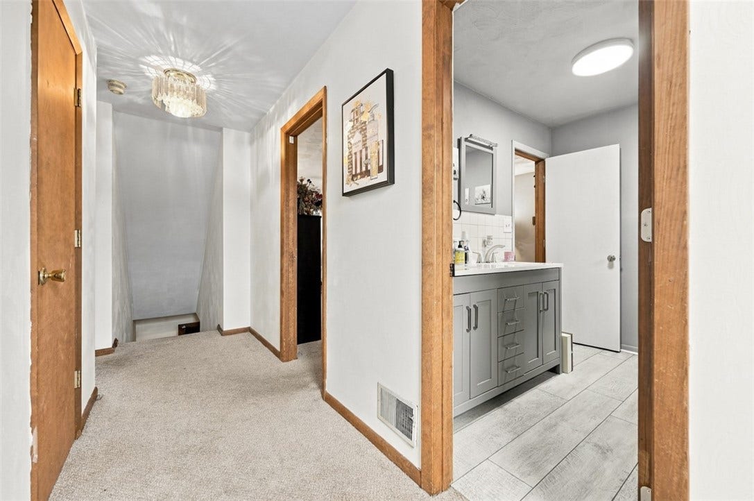 A smart layout that keeps everything connected- easy hallway access to the full bath, bedrooms, and stairs, all from one central spot!