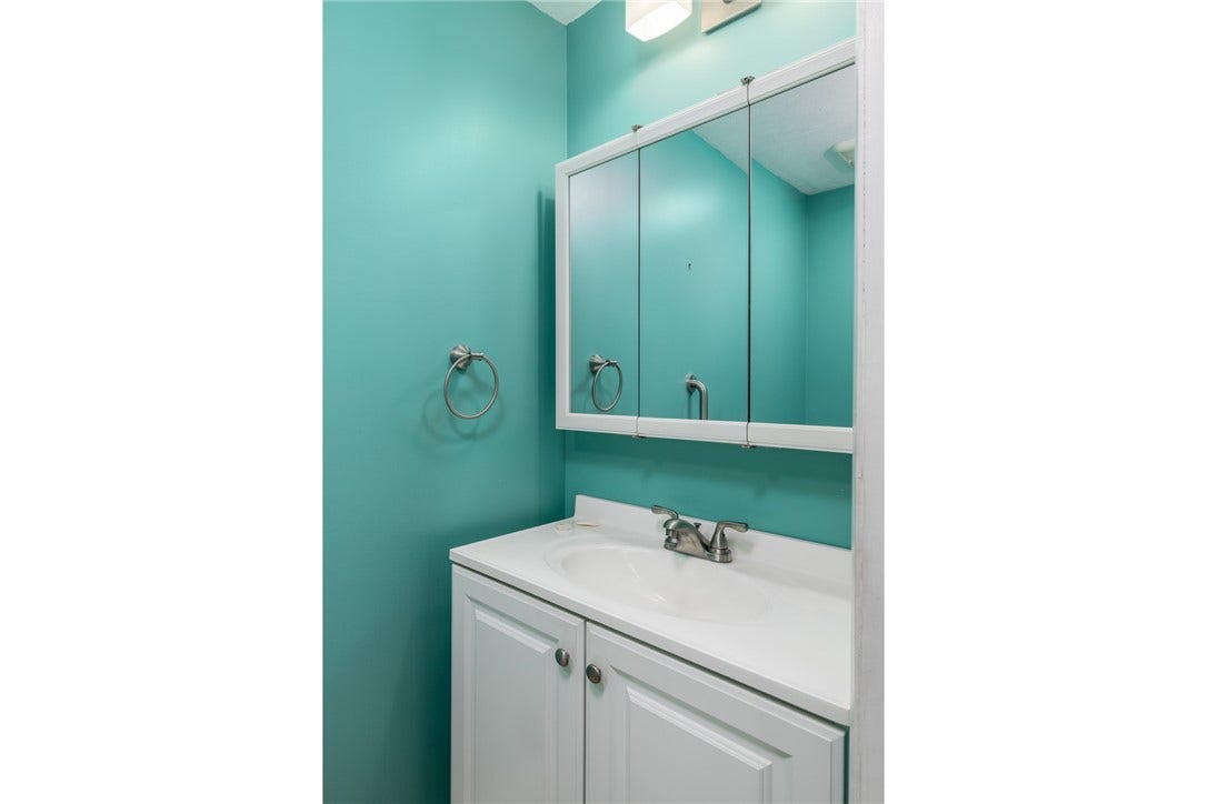 HALF BATH LOCATED ON THE FIRST FLOOR JUST OFF THE LAUNDRY ROOM