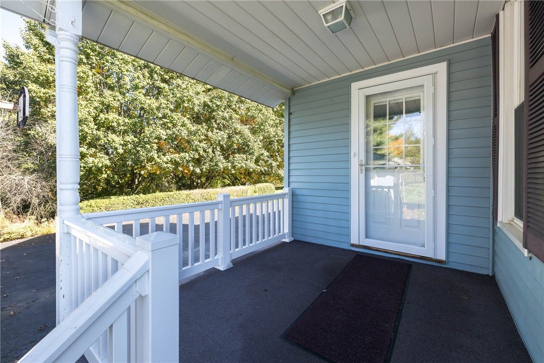 8'10" X 7'8" COVERED BACK PORCH WITH ENTRY TO THE LAUNDRY ROOM - EASILY ACCESSIBLE FROM THE GARAGE.