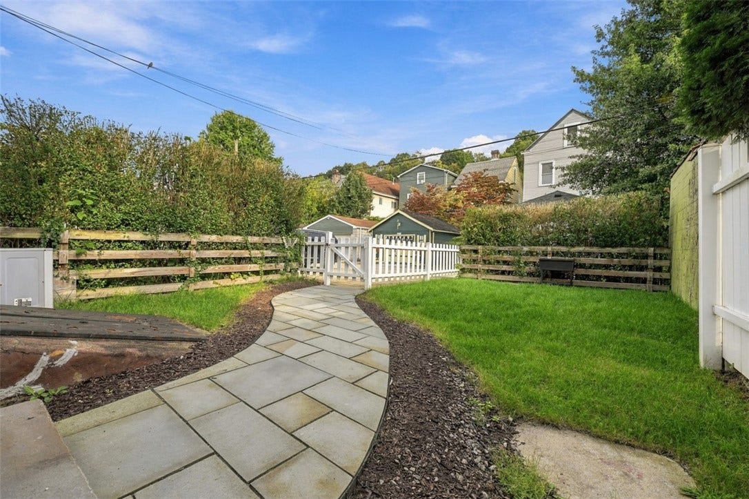 123 4th Street, Pittsburgh, PA 15215 Attractive back yard with stone path, fenced in and access to the parking area.