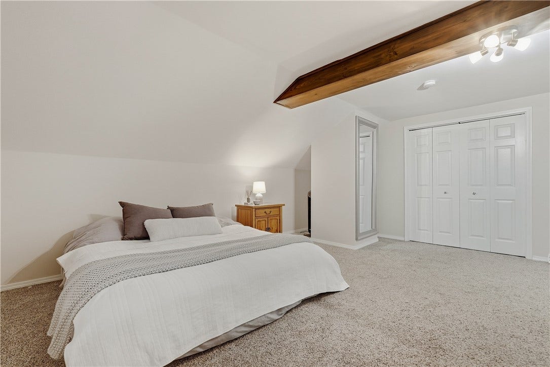 BR3. Second floor primary BR that has a double closet, vaulted ceiling and private full bath with shower.