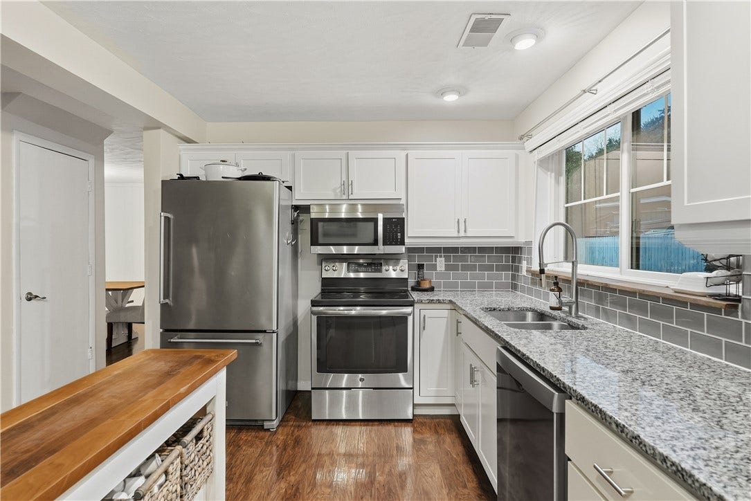 Remodeled Kitchen with white shaker cabinets, stainless steel appliances and granite tops!