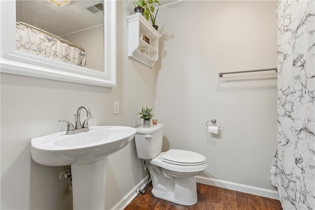 Full Bathroom on 1st Floor with tub/shower, pedestal sink and linen closet.