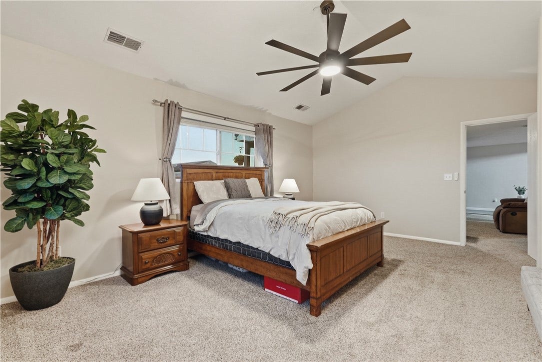 Bright 1st Floor Primary Bedroom with double closet and niche for future second closet or desk area. Vaulted ceilings with new fan/light.