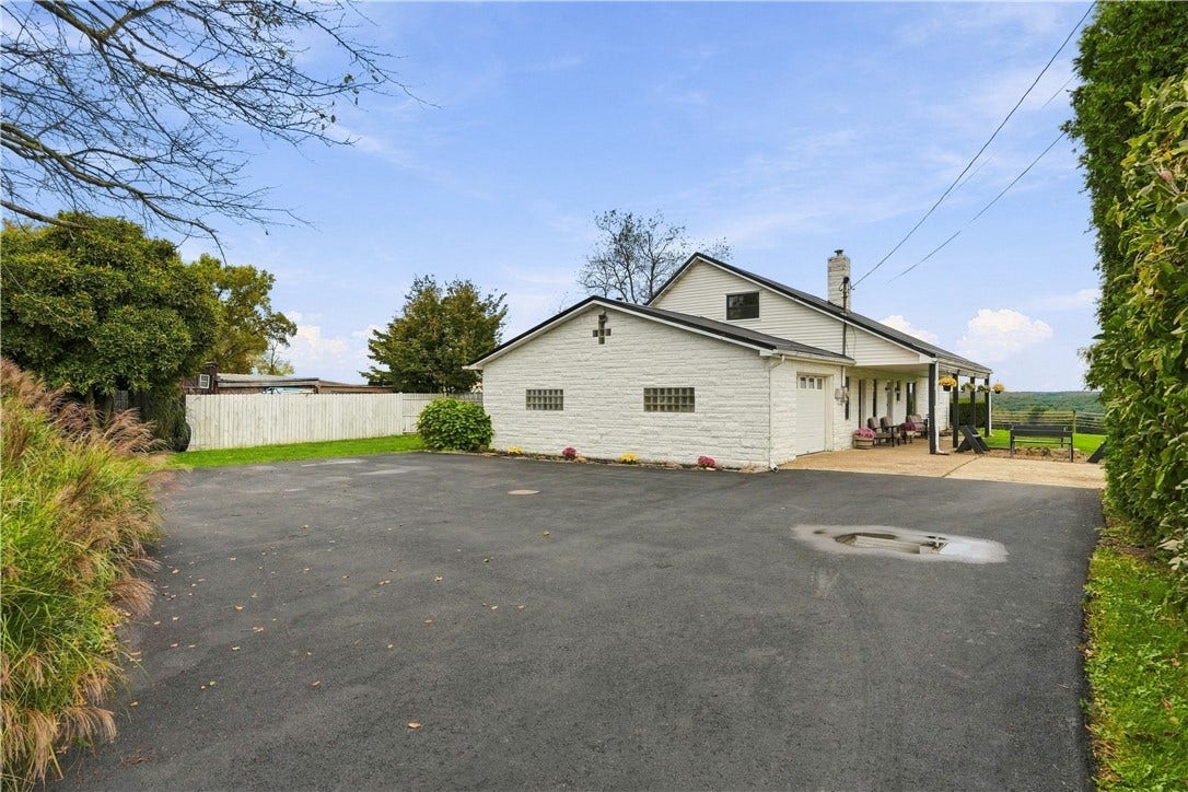 Newly paved parking pad adjacent to oversized attached garage