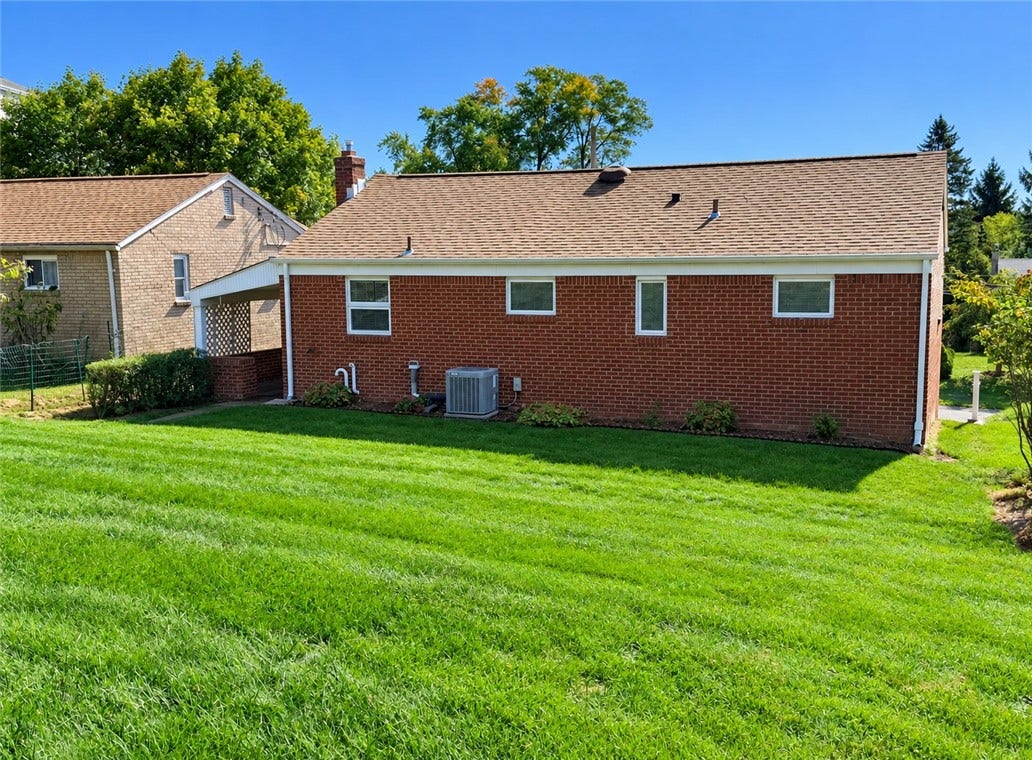 A lovely yard with a solid brick house