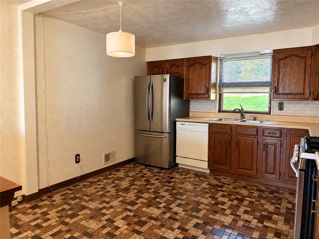 This eat in kitchen has plenty of room for a table or banqette.