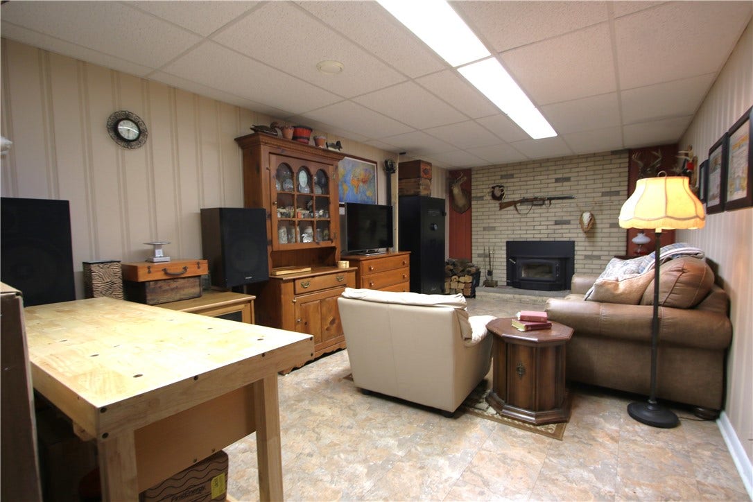 4239 Finleyville Elrama Road, Finleyville, PA 15332 Enormous 25x11 Finished Game Room highlighted by Brick Wood Burning Fireplace & Attractive Tile Flooring.