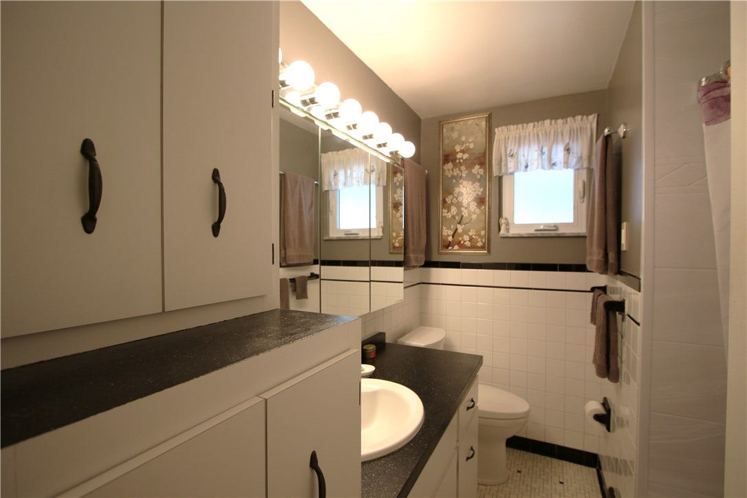 4239 Finleyville Elrama Road, Finleyville, PA 15332 Abundance of Cabinetry in Full Bathroom w/ Ceramic Tile Floors & partial Ceramic Wall Tiled Walls, Triple Mirrored Medicine Cabinet enhanced by Vanity Lighting. Easy-Care Bath Fitter Tub & Surround installed appx 6 years ago plus Laundry Chute!