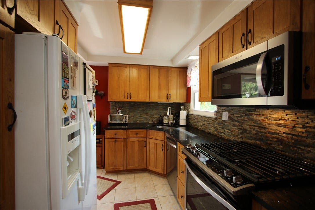 4239 Finleyville Elrama Road, Finleyville, PA 15332 Plenty Of Quality Wood Cabinets & Gorgeous Stone Backsplash! Side Door opens to 12x5 porch leading onto Incredible 18x18 Deck