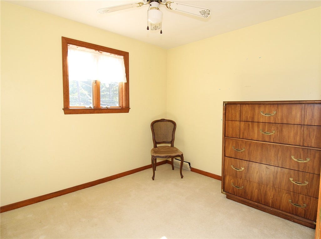 Add a warm paint and window treatments to create your own space.