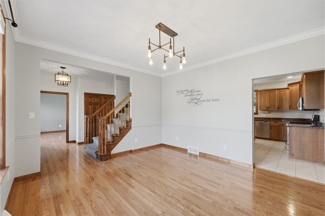 The Dining Room is approximately 13'x13' and features beautiful crown molding, hardwood floors, and both natural and overhead lighting for a well-lit dining area. The dining room flows right into the kitchen.