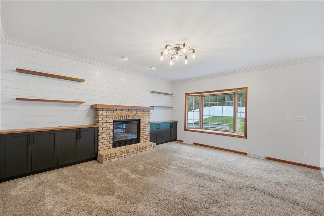 The Living Room is approximately 15'x17' and flows right from the kitchen, creating a very open-concept feel. The living room features a big, beautiful bay window, gas fireplace, and custom, built-in cabinets.