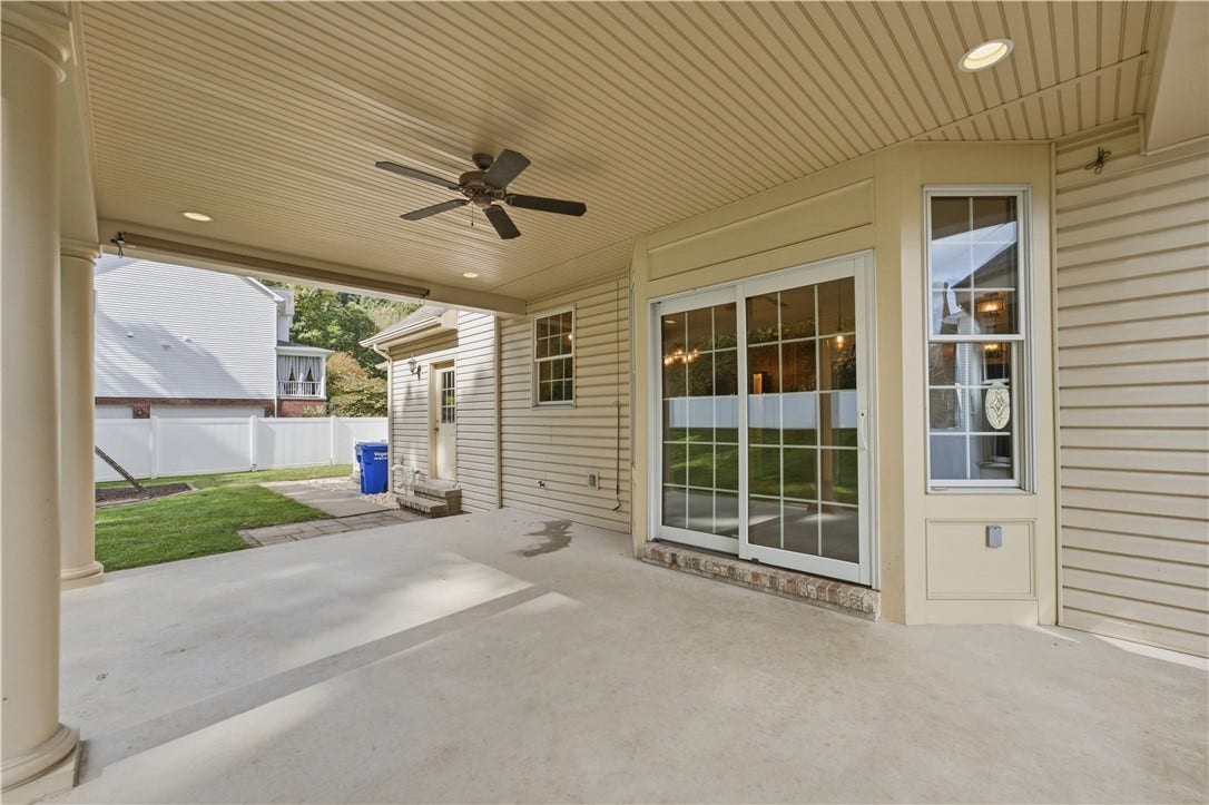 The covered, back patio is a great spot to hang out and enjoy the outdoors and it even features overhead lighting for after it gets dark