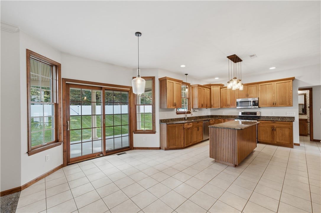 The Kitchen is approximately 22'x15' and flows right from the dining room. The huge kitchen area features granite countertops, custom cabinetry, stainless steel appliances, ample recessed lighting, a large kitchen island, and an open concept feel into the Living Room
