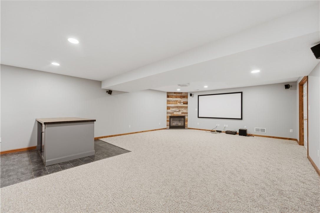 The Basement Game Room is approximately 19'x27' and features a very nice dry bar area, fireplace, tons of room for furniture, recessed lighting, and even a projection screen and projector! What an entertainment room!