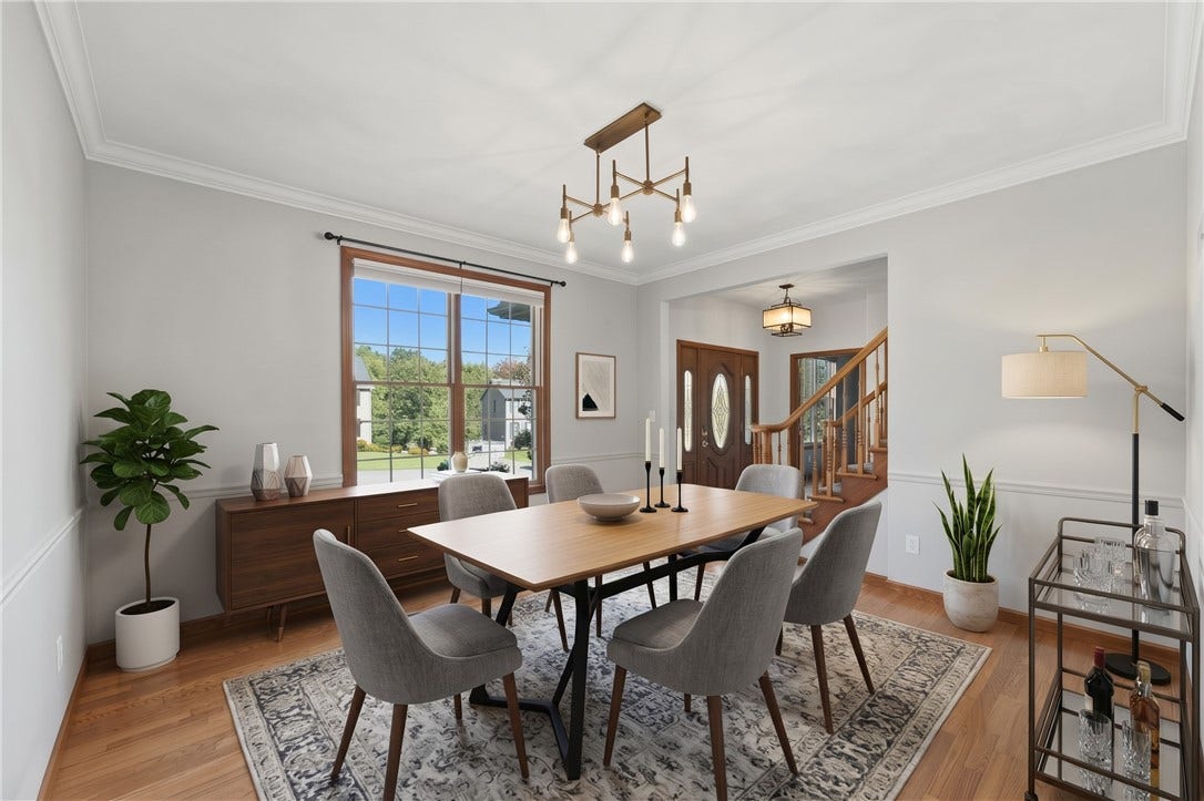 The Dining Room has been digitally staged to inspire decorating ideas! The Dining Room is approximately 13'x13' and features beautiful crown molding, hardwood floors, and both natural and overhead lighting for a well-lit dining area.