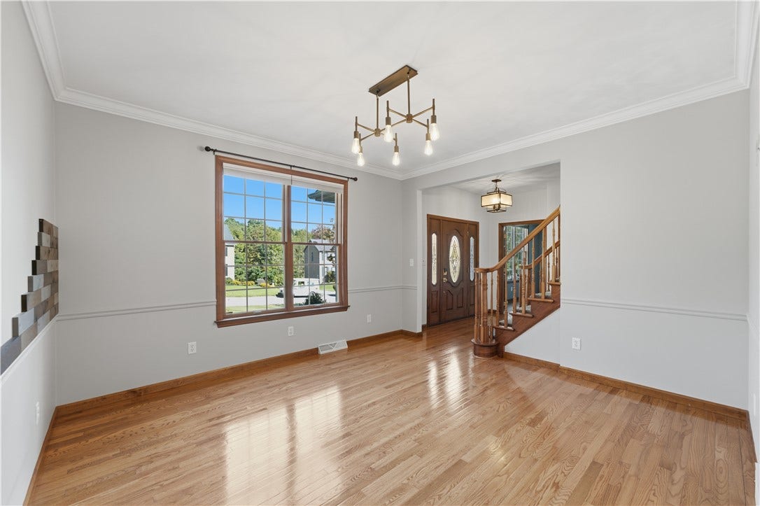 The Dining Room is approximately 13'x13' and features beautiful crown molding, hardwood floors, and both natural and overhead lighting for a well-lit dining area.