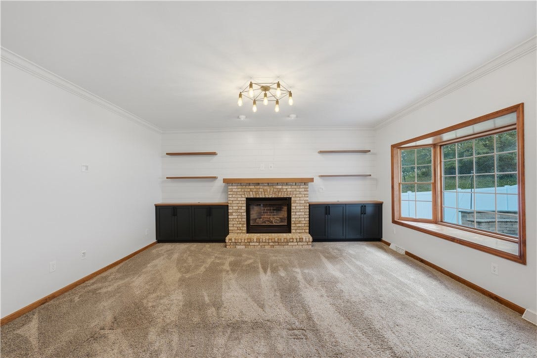 The Living Room is approximately 15'x17' and flows right from the kitchen, creating a very open-concept feel. The living room features a big, beautiful bay window, gas fireplace, and custom, built-in cabinets.