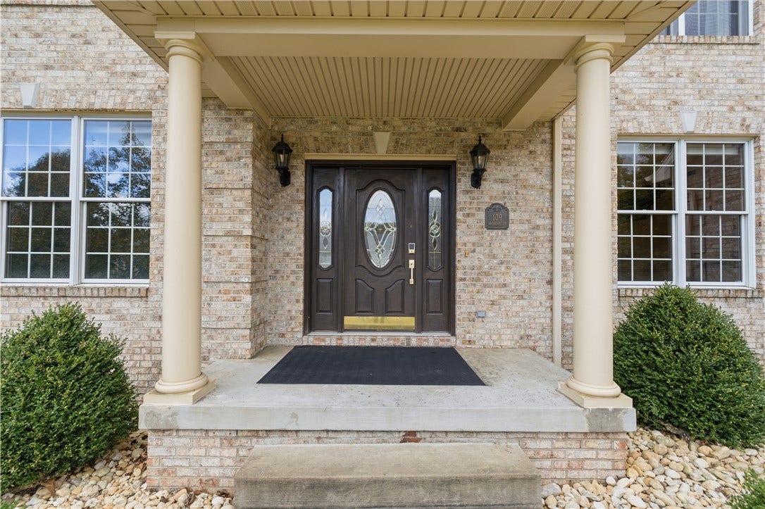 The main entrance features a covered front patio with tasteful pillars to accent the brick front. Come on in!