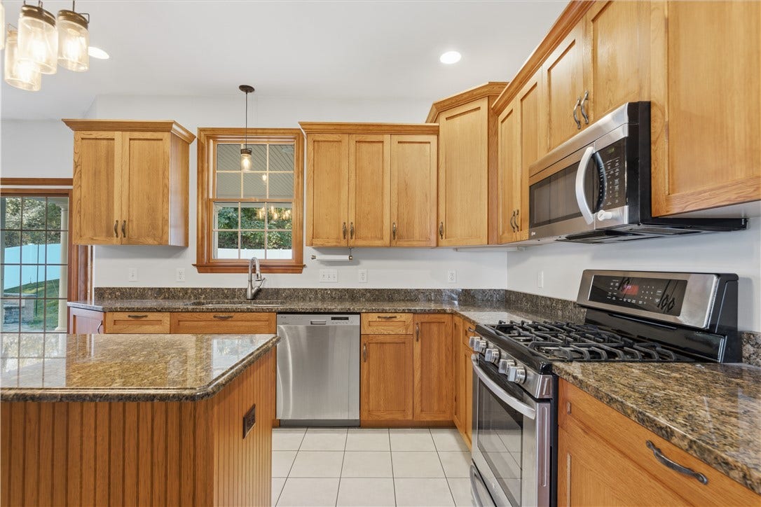 The Kitchen is approximately 22'x15' and flows right from the dining room. The huge kitchen area features granite countertops, custom cabinetry, stainless steel appliances, ample recessed lighting, a large kitchen island, and an open concept feel into the Living Room